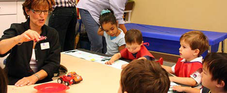 photo of children listeing to teacher